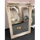 An ivory style swept frame mirror