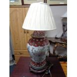 A Chinese table lamp on wooden stand