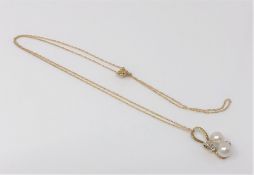 A 10ct gold diamond and pearl pendant on chain