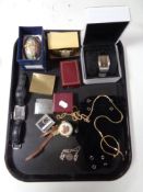 A tray of gent's wristwatches, DKNY, decorative eggs, Penguin lighter,