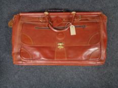 A vintage leather Henry valise together with three other leather cases and bags