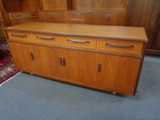 A mid century teak G-plan four drawer low sideboard