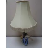 A Nao figural table lamp with shade - Girl with bird in hand