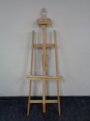 A folding artists easel together with a wooden rule