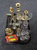 A tray of glass, brass candlesticks, mincer,