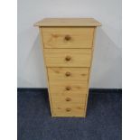 A pine effect six drawer chest