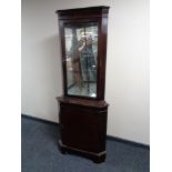 A mahogany corner display cabinet