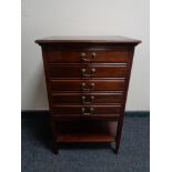 An Edwardian mahogany five drawer music cabinet