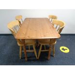 A pine kitchen table and four chairs