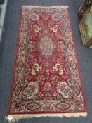 A machines oriental rug on red ground,