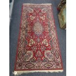 A machines oriental rug on red ground,