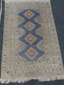 A fringed Eastern rug on cream ground,