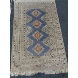 A fringed Eastern rug on cream ground,