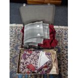A vintage luggage case and box of curtains