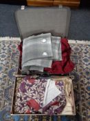 A vintage luggage case and box of curtains