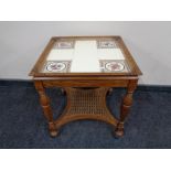 A continental oak tiled table with begere undershelf together with a further pair of tiled lamp