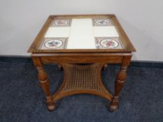 A continental oak tiled table with begere undershelf together with a further pair of tiled lamp