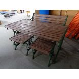 A cast iron wooden garden bench and two stools