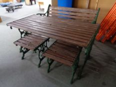 A cast iron wooden garden bench and two stools