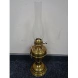 A vintage brass Duplex oil lamp with glass chimney