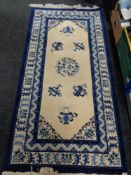 A blue fringed Chinese rug,