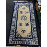 A blue fringed Chinese rug,