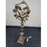 An early twentieth century pot metal table lamp on marble base and raised feet