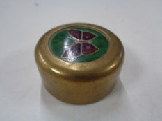 A brass and enamelled paper weight