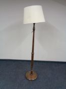 An early twentieth century oak standard lamp with shade
