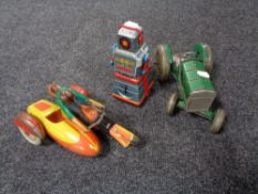 A mid century tin plated tractor together with a tin plated robot and motorbike with sidecar