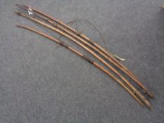 Four tribal longbows CONDITION REPORT: Approximate lengths 155 cm