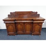 A Victorian mahogany inverted breakfronted sideboard on bun feet
