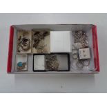 A box of silver jewellery, rings, necklaces,