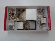 A box of silver jewellery, rings, necklaces,