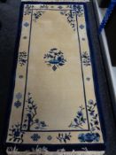 A blue fringed Chinese rug,