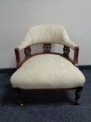 A Victorian mahogany elbow chair upholstered in cream floral fabric