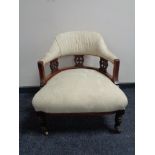 A Victorian mahogany elbow chair upholstered in cream floral fabric