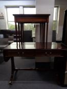 A reproduction mahogany sofa table and a nest of three tables
