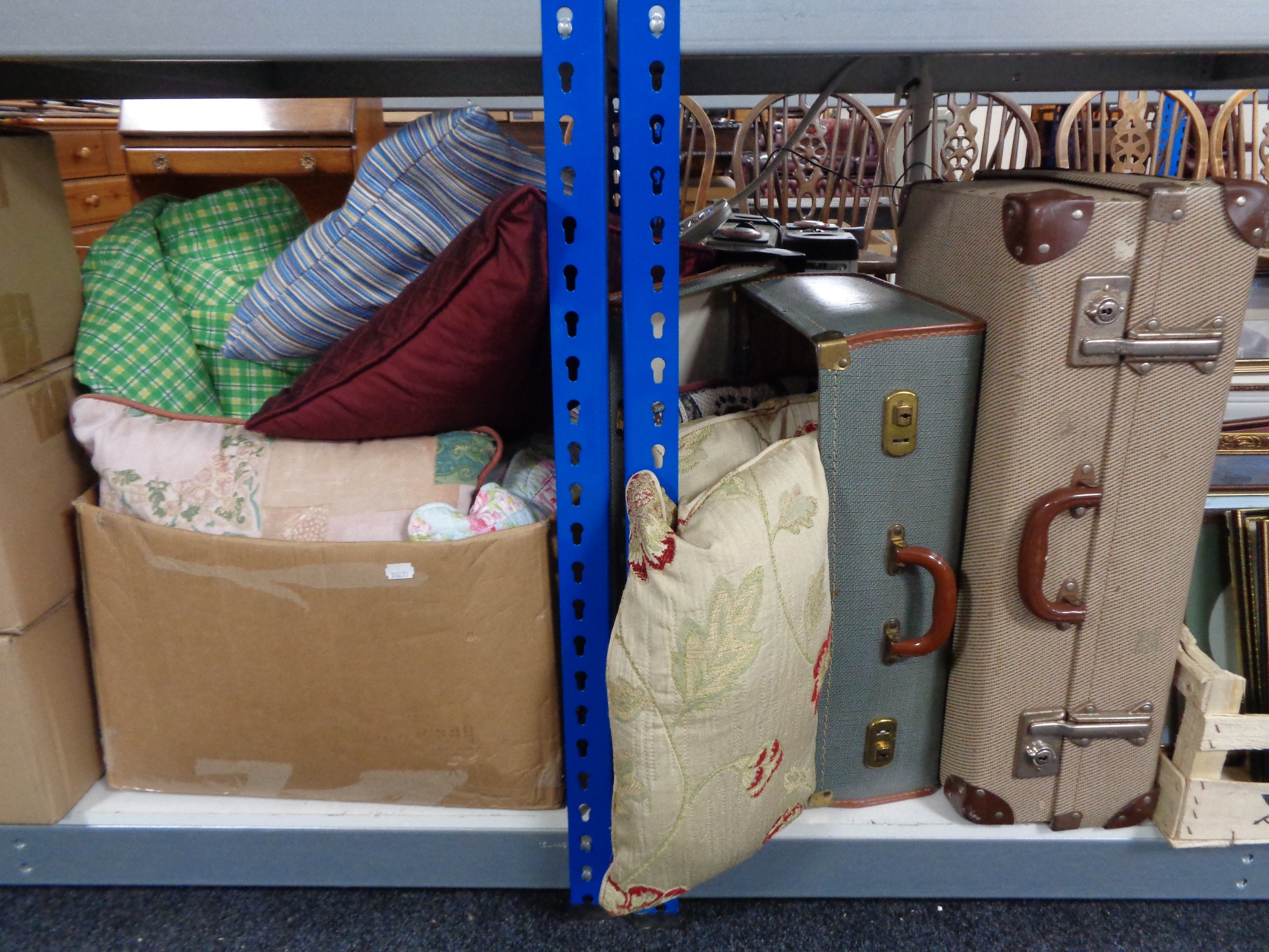 Two vintage luggage cases and a box of assorted cushions and blanket