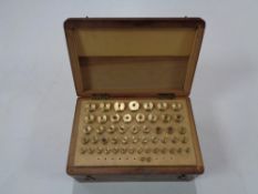 A cased set of brass