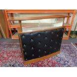 A mid 20th century teak black vinyl upholstered cocktail bar