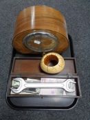 A tray of walnut cased Deco style mantel clock, wooden table box of novelty bank notes, spanner,