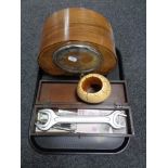A tray of walnut cased Deco style mantel clock, wooden table box of novelty bank notes, spanner,
