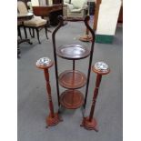 An Edwardian folding cake stand and two smoker's stands