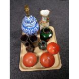 A tray of Oriental wares, blue and white table lamp, famille rose vase,