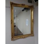 A mirror in decorative gilt frame 65 cm x 90 cm