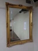 A mirror in decorative gilt frame 65 cm x 90 cm