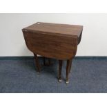 An oak gate leg table on club feet