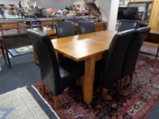 A contemporary oak extending dining table,