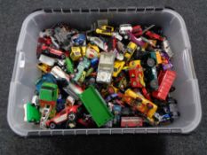 A plastic storage box of play worn die cast vehicles,